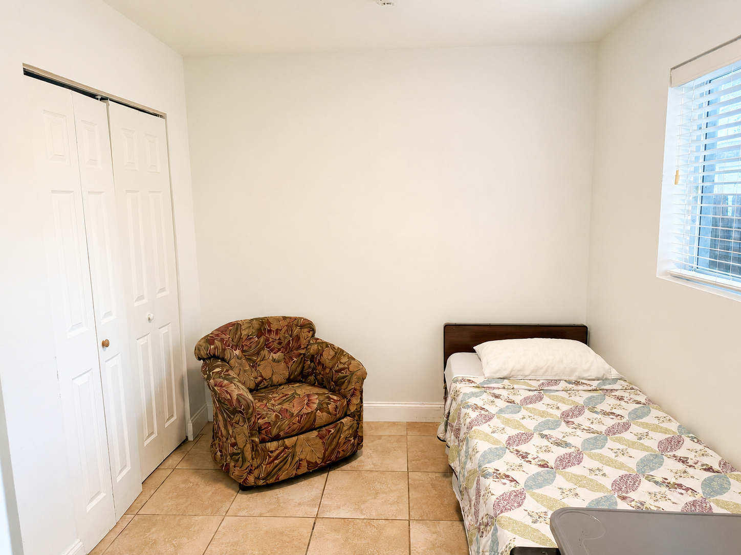 A resident's private bedroom suite at Atlantis Senior Care Residence, warmly decorated with string lights and personal touches